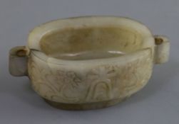 A Chinese grey jade brushwasher, 18th/19th century, of oblong form, the sides carved in relief