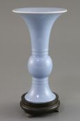 A Chinese clair de lune trumpet vase, gu, Qing dynasty, finely potted, with white glazed rim, the