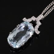 A mid 20th century white gold? mounted oval cut aquamarine pendant with diamond set bale, on a later