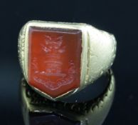 A 19th century yellow metal and carnelian set signet ring, the matrix carved with castle turret