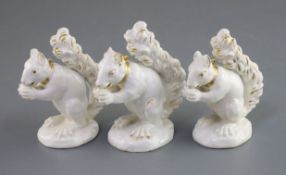 Three Derby porcelain figures of a squirrel, c.1800-30, each in gilt and white including a pair with