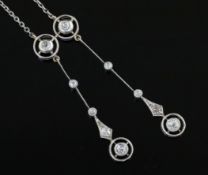An early 20th century gold, silver and diamond set graduated double drop pendant, on a fine link