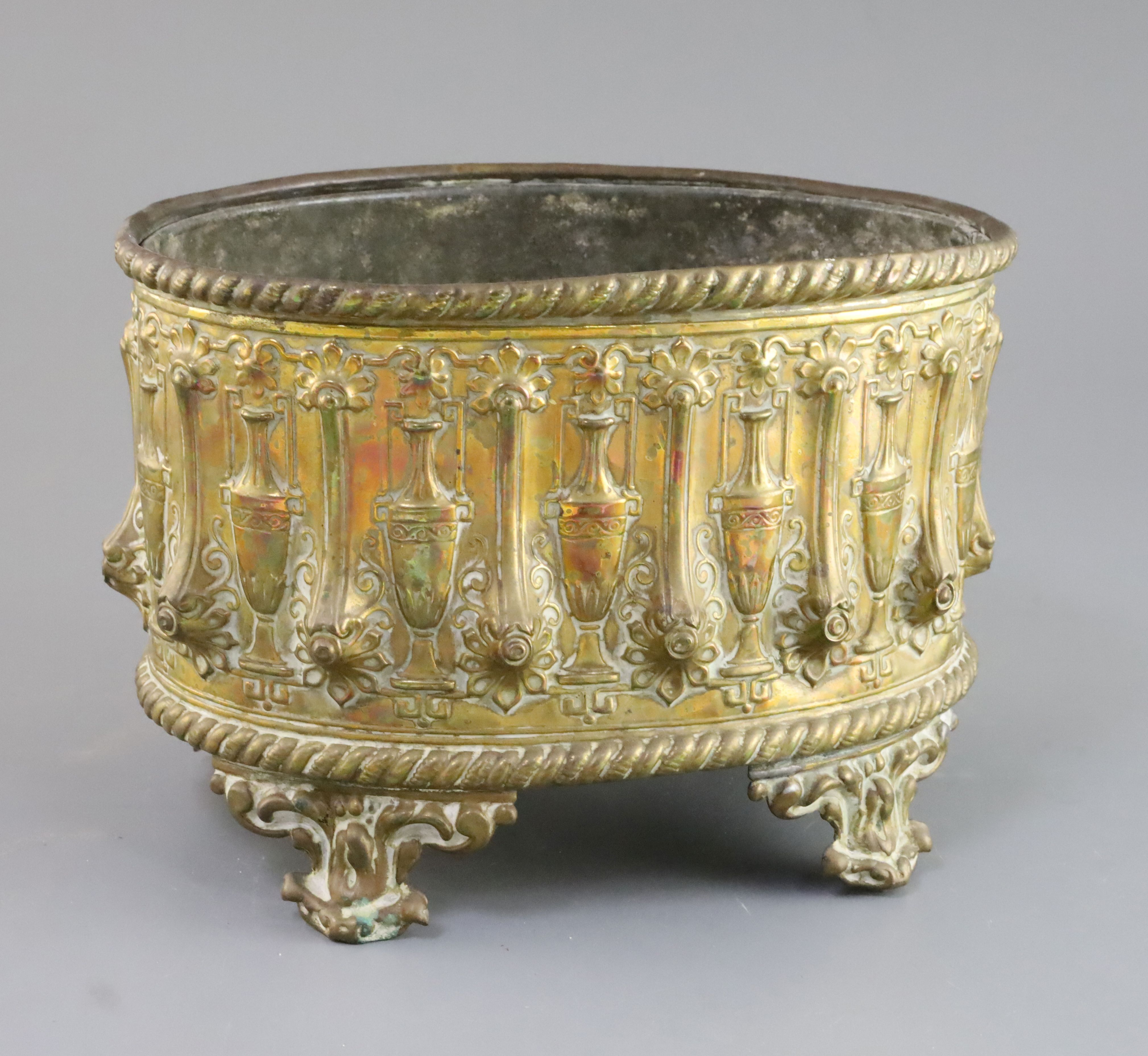 A Regency embossed and gilt brass jardiniere with tin liner, decorated with Grecian urns, 9.5in.