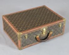 A Louis Vuitton suitcase, with brass mounted LV fabric, no.957179, 20 x 14.5 x 7in.