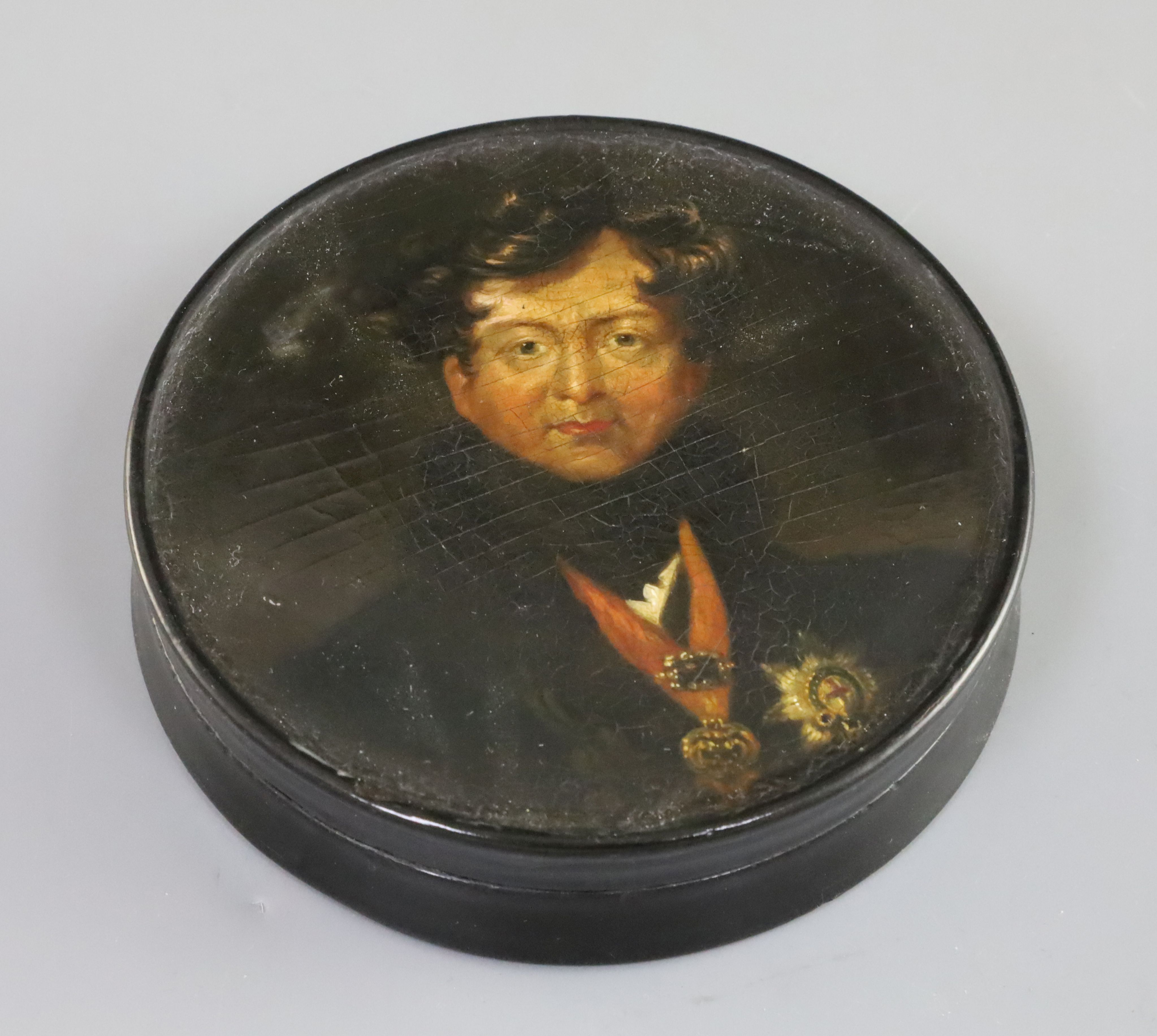Samuel Raven (1775-1847). A papier mache snuff box, painted with a portrait of George IV after Sir