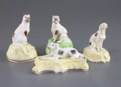 Four Samuel Alcock porcelain figures of dogs, c.1840-50, comprising a recumbent setter on a yellow