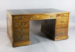 An early 19th century boxwood strung mahogany pedestal desk, with triple green leather skiver, inset