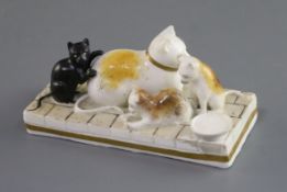 A Rockingham porcelain group of a cat and three kittens, c.1826-30, including a rare black kitten,