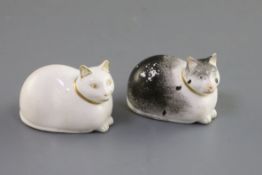 Two Derby porcelain figures of recumbent cats, c.1830, the black and white cat with red printed '