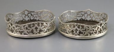 A pair of Victorian foliate-pierced silver bottle coasters with wavy gadrooned rims, London 1841,