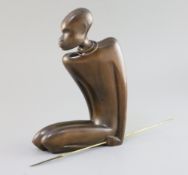 A Hagenauer hardwood figure of a kneeling native man holding a brass spear, stamped marks to base,