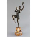 Attributed to G. Limousin. A bronzed metal and ivory figure of a pan pipe dancer, on two colour
