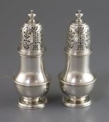 A good pair of early George II silver casters, by Thomas Bamford, of baluster form, with turned