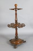 An early Victorian mahogany boot rack with eight pegs and divisions, on scroll feet H. 3ft 7in.