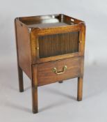 A George III mahogany tray top commode, with tambour fronted compartment and base drawer, on squared