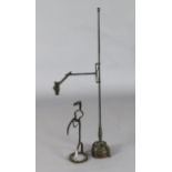 A 17th century wrought iron rushlight holder, with telescopic stem and loaded hardwood base,