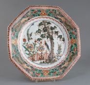 A Chinese famille verte octagonal dish, Kangxi period, painted with two courting birds in a garden