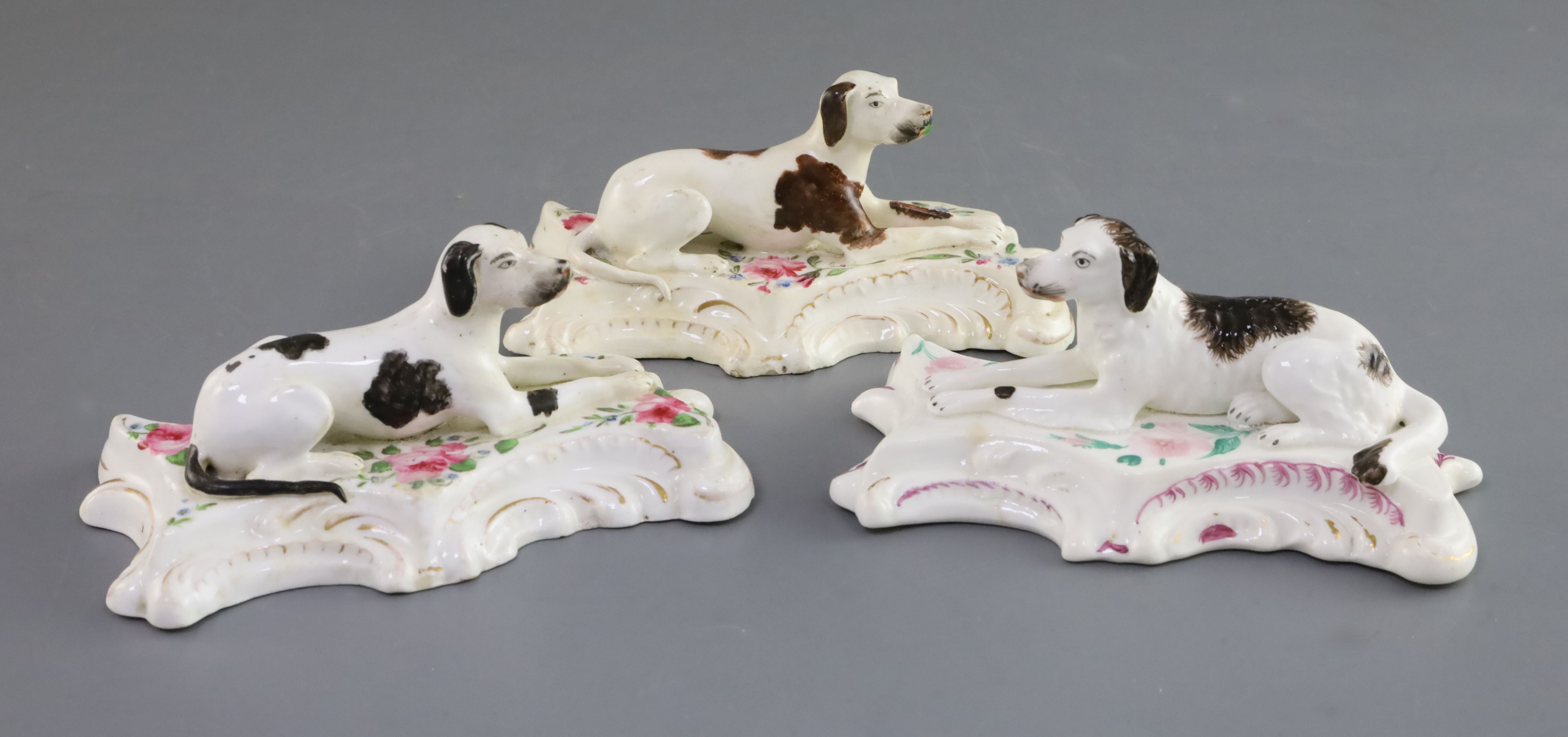 Three Derby porcelain figures of a setter and two pointers, c.1835-46, each recumbent on flower