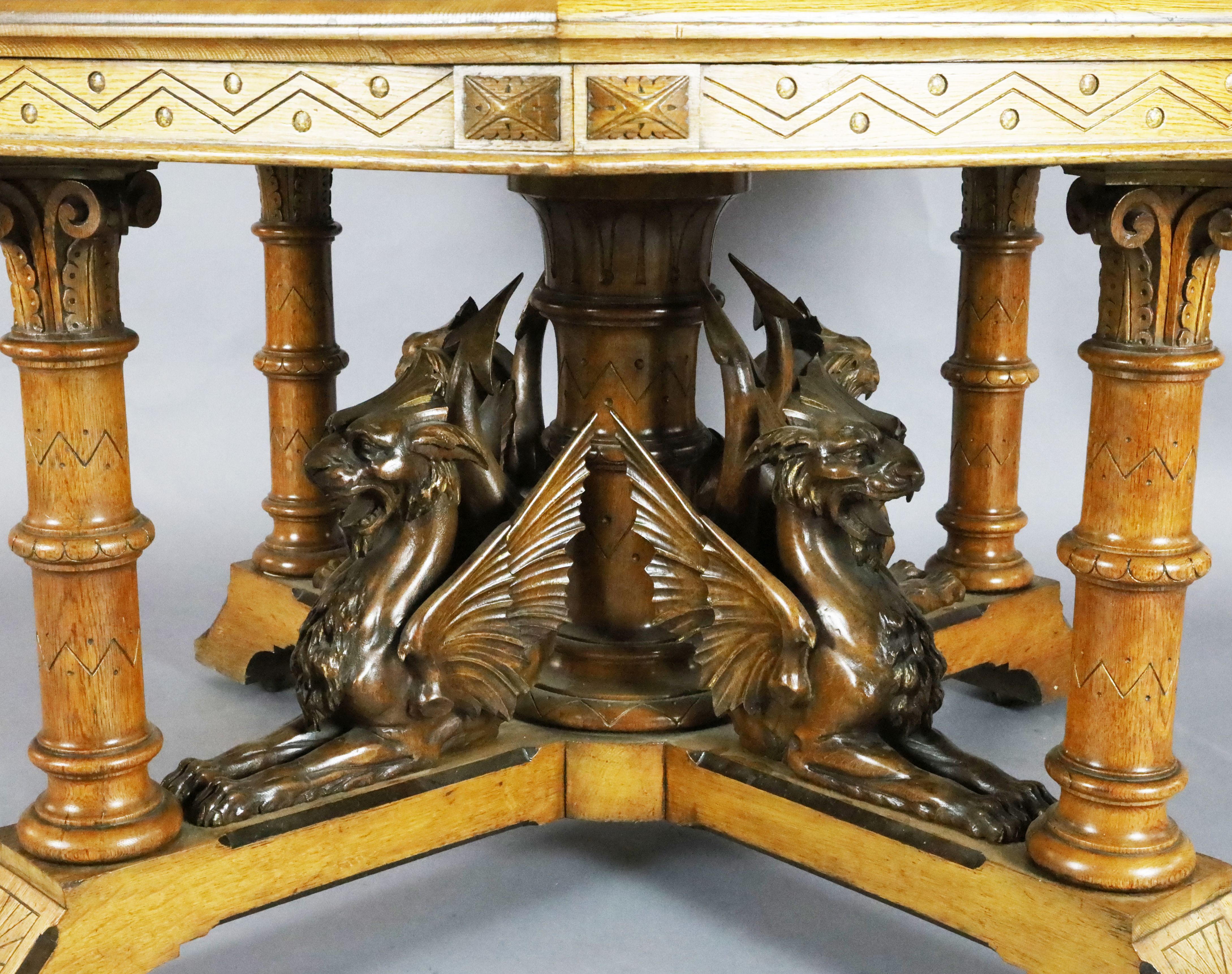A Victorian Gothic revival golden oak centre table, with octagonal top, the underframe carved with - Image 2 of 4