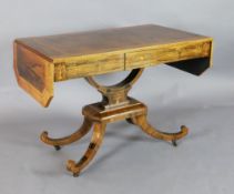 A Regency crossbanded and marquetry inlaid rosewood sofa table, with canted rectangular flaps and