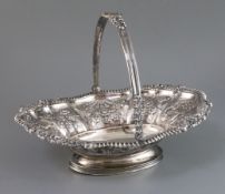 A George IV embossed silver swing-handled cake basket, James Kirby & Joseph Waterhouse, decorated