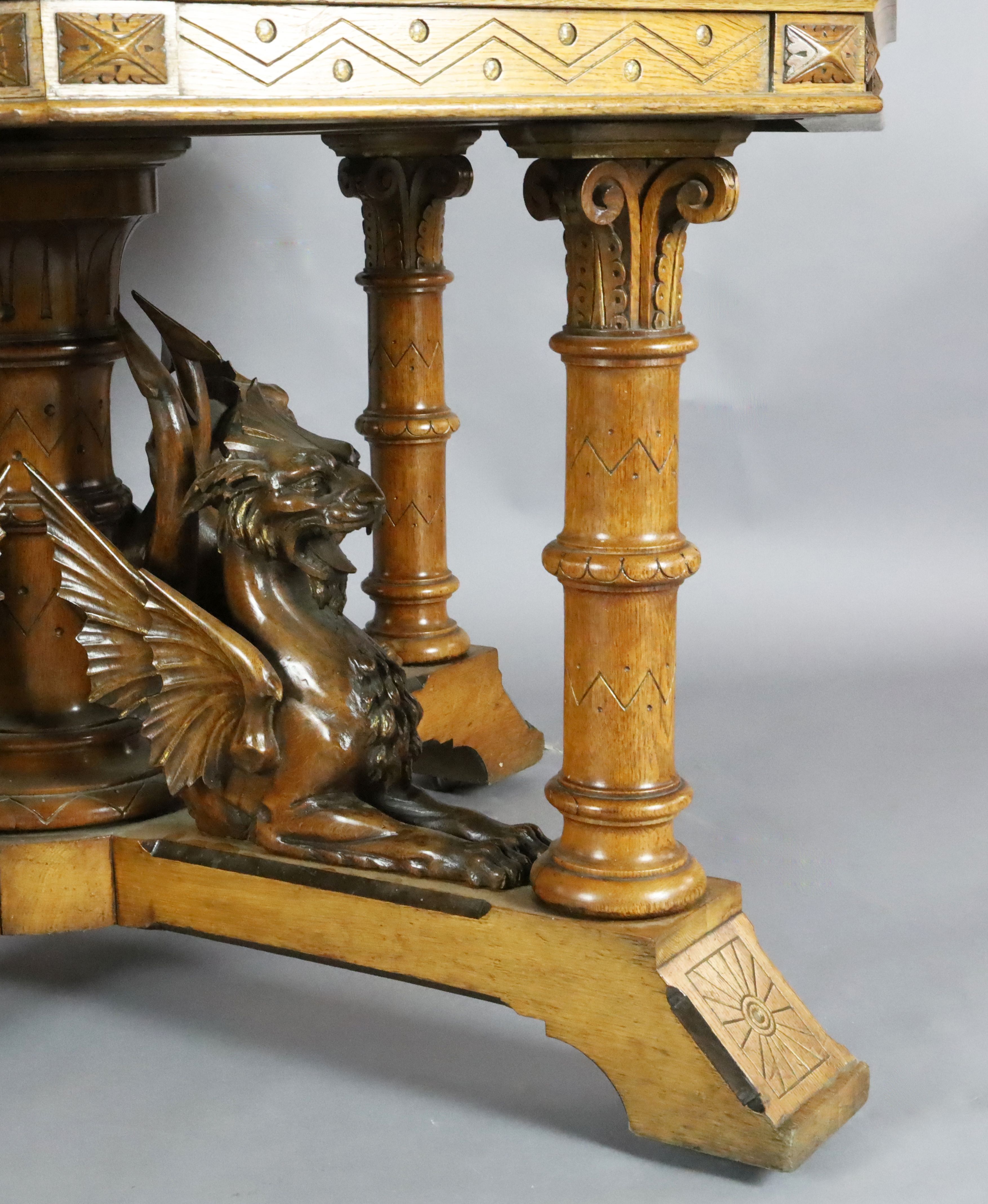 A Victorian Gothic revival golden oak centre table, with octagonal top, the underframe carved with - Image 3 of 4