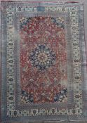 A Persian blue ground carpet, with field of scrolling foliage and multi row border (worn), 17ft 11in