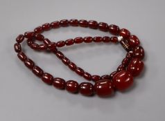 A single strand graduated simulated cherry amber necklace, gross 95 grams, 74cm.