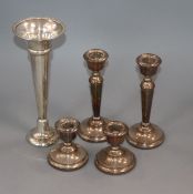 Two pairs of silver candlesticks and a silver trumpet vase.