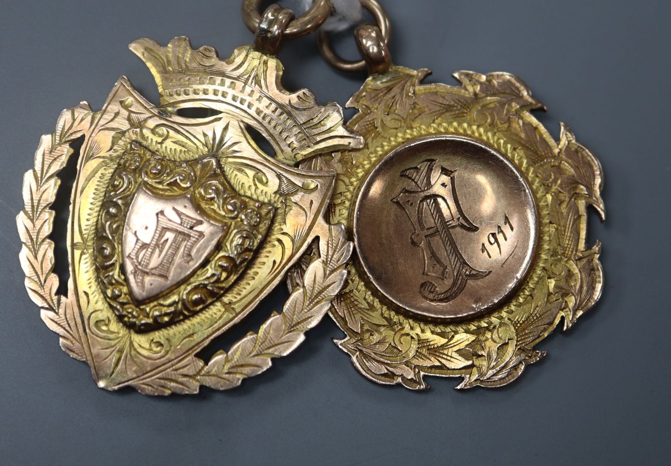 Two early 20th century 9ct gold angling medals awarded by Burslem Angling Society in 1911 and 1915.