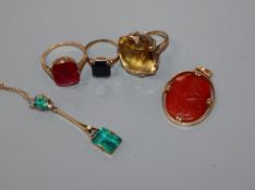 Three assorted yellow metal rings including 10k and two pendants including 9ct and one with carved