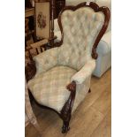 A Victorian carved mahogany framed spoonback buttoned back armchair