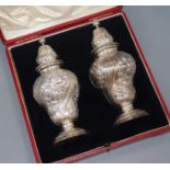 A cased pair of late Victorian silver sugar casters, Daniel & John Welby, London, 1897, 19.2cm, 14.5