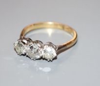An 18ct and plat, three stone diamond ring, size P/Q