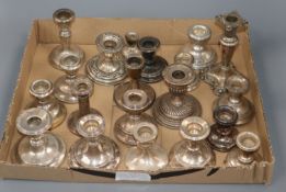 Twenty assorted early 20th century and later silver dwarf candlesticks, of varying sizes.