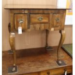 A George III oak and walnut lowboy, fitted three drawers on cabriole legs and horse hoof feet W.