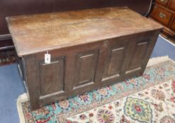 An 18th century panelled oak coffer W.124cm