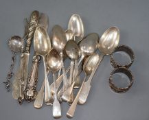 Twelve items of 18th and 19th century flatware and six other items including a pair of silver napkin