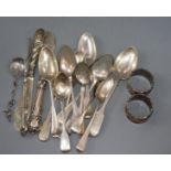 Twelve items of 18th and 19th century flatware and six other items including a pair of silver napkin