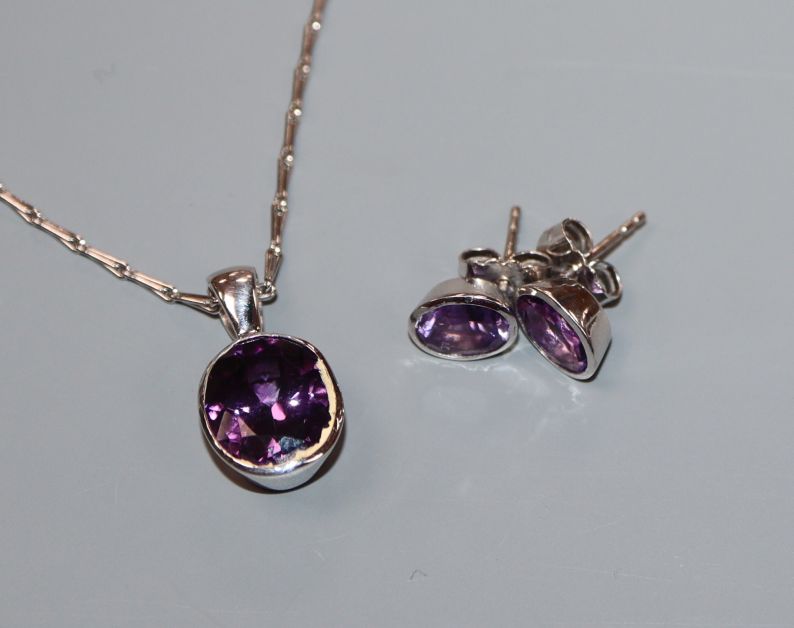 A modern white metal and amethyst suite of jewellery, comprising a pendant on 750 chain and a pair