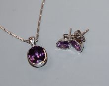 A modern white metal and amethyst suite of jewellery, comprising a pendant on 750 chain and a pair