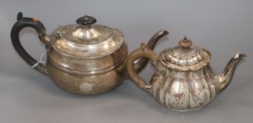A George V Scottish silver teapot of plain oval form and an Edwardian bachelor's teapot of fluted
