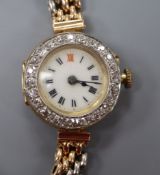 A lady's Edwardian 18ct gold manual wind wrist watch with diamond set bezel, on a two colour