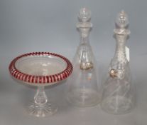 A pair of late Regency glass decanters, with silver Claret labels and a ruby overlaid cut glass