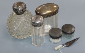 A silver-mounted scent bottle, four other toilet jars and a trowel book mark.