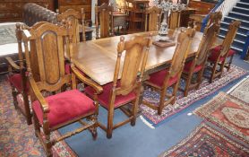 An oak drawleaf refectory table and twelve chairs, two with arms