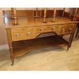 A 19th century mahogany two-tier writing table, inlaid and fitted three drawers on turned supports