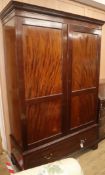 An Edwardian mahogany wardrobe fitted drawer to base W.134cm