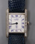 A lady's sterling Must de Cartier quartz rectangular wrist watch with diamond set bezel, in