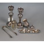 A pair of silver mounted candlesticks, two silver mounted condiments, a pair of sugar tongs and